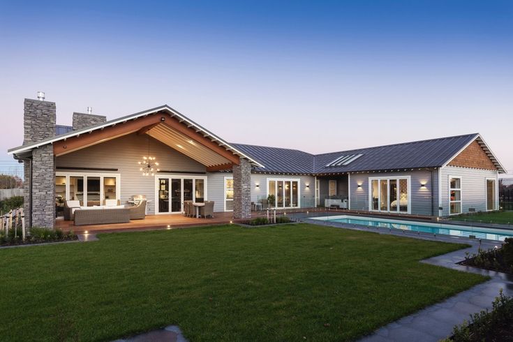 a house with a swimming pool in the front yard and lawn area next to it