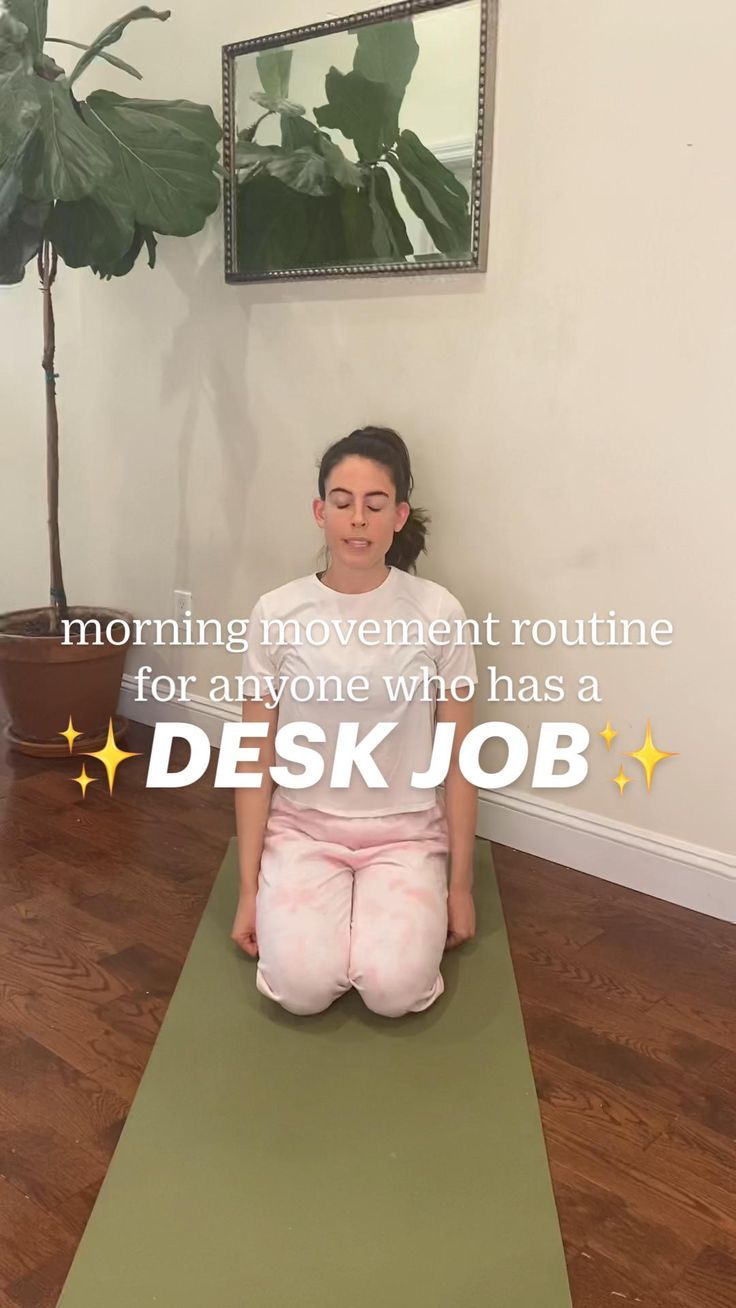 a woman sitting on top of a yoga mat