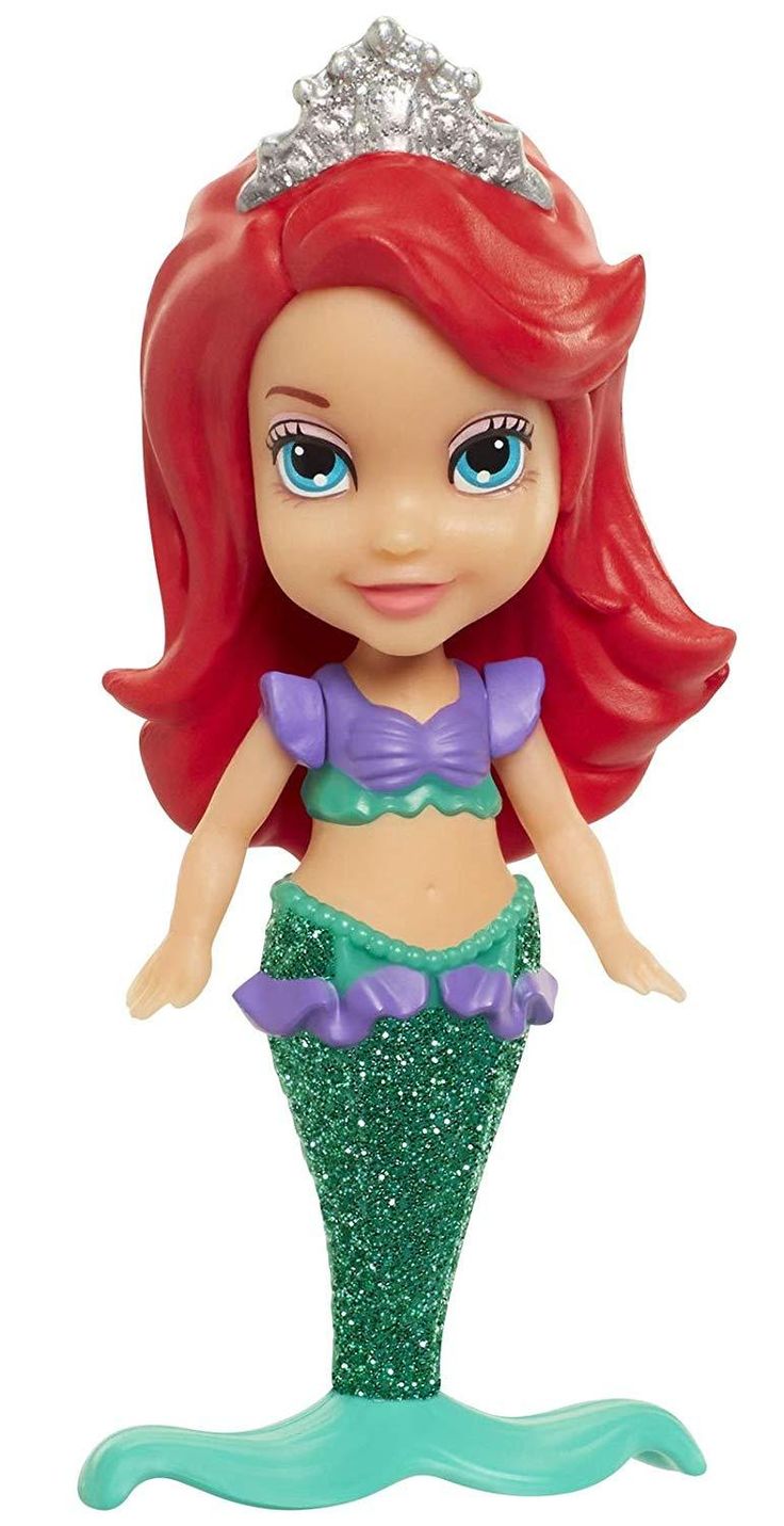 the little mermaid doll has red hair and is wearing a green dress with silver sequins