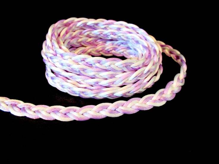 a purple and white braided rope on a black background