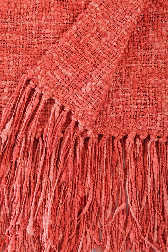 an orange blanket with fringes on it