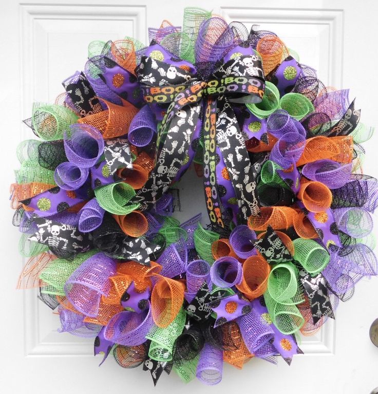 a halloween wreath with purple, green and orange mesh ribbons hanging ...