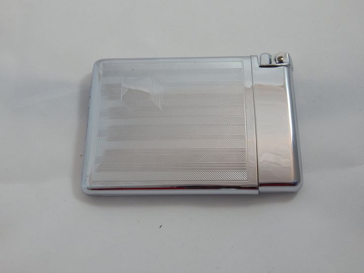 a silver lighter sitting on top of a white table