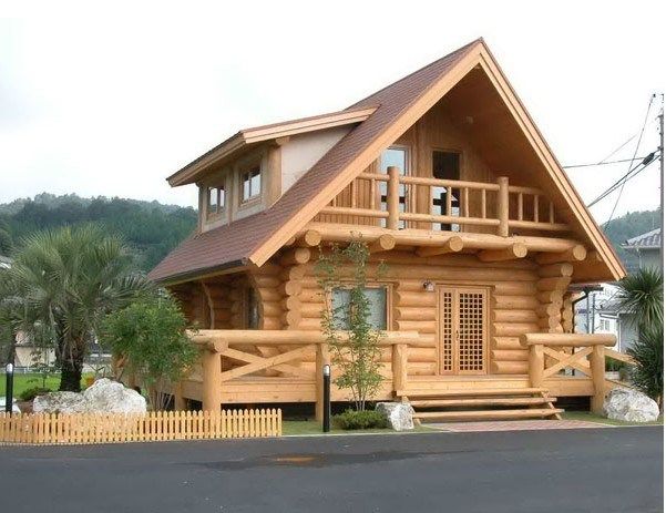 a small wooden house sitting on the side of a road