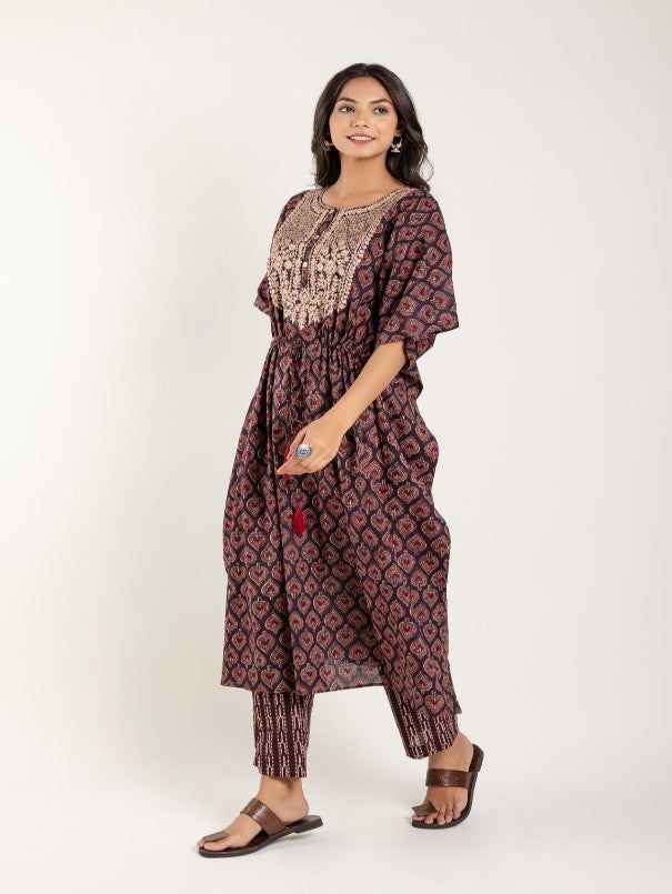 Brown geomatric printed kaftan with zari work details on yoke, has a round neck, short sleeves, string on waist and stripes printed pant has partially elasticated waistband Fabric: 100% Cotton Color: Brown Note: Available in other colors Wash Care Instruction - Dry Clean Only The product will be shipped within 15-20 days of order placed Size Chart: Kaftan Size XS S M L XL XXL XXXL Bust 38 40 42 44 46 48 Waist 38 40 42 44 46 48 Hip 38 40 42 44 46 48 Shoulder Armhole Sleeve Length 12 12 12.5 12.5 Multicolor Straight Kurta With Tassels, Cotton Kurta With Tassels For Eid, Eid Cotton Kurta With Tassels, Cotton Tassel Sets For Navratri, Bohemian Cotton Sets With Short Sleeves, Bohemian Cotton Sets With Tassels, Bohemian Short Sleeve Festive Sets, Cotton Kurta With Tassels For Navratri, Casual Festive Sets For Navratri