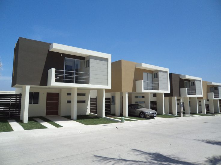 a row of houses with cars parked in front