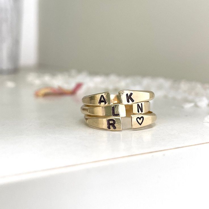 Our Personalized Open Cuff Ring might be small but it makes a mighty statement. This gorgeous minimalist style ring is perfect for stacking two, three, even four or layering with other ring styles. The fact that you can personalize it with initials and other designs just make it even better or leave it blank, it's totally up to you. Besides initials, this piece can be personalized with numbers, hearts, stars,s or flower symbols. This ring is hand-made and stamped in our studio at the time of order, of heavy 10 gauge 14kt gold filled metal wire. It's about 2mm thick and has an organic shape that is created by working the metal. This ring is 100% 14kt gold-filled, it is very durable and will wear very well with appropriate care, it will not change color or discolor your skin. I promise you'r Adjustable Hand Stamped Initial Ring Minimalist, Adjustable Hand Stamped Minimalist Initial Ring, Adjustable Minimalist Hand Stamped Initial Ring, Simple Stackable Initial Ring For Everyday, Modern Personalized Round Band Jewelry, Stacked Minimalist Midi Rings, Modern Adjustable Engraved Open Ring, Modern Adjustable Open Engraved Ring, Dainty Stackable Initial Open Ring