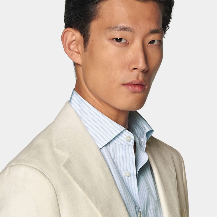 Cut to a relaxed fit, this off-white suit features a jacket with a natural shoulder and accompanying flat-front trousers with a straight-leg and belt loops. Beige Semi-formal Spring Suits, White Classic Blazer With Concealed Placket, White Long Sleeve Suit With Single Button, Beige Suits For Business In Spring, White Business Blazer With Concealed Placket, White Notch Lapel Blazer With Concealed Placket, Spring Beige Business Suits, Classic White Blazer For Business Casual, White Blazer With Concealed Placket And Lapel Collar