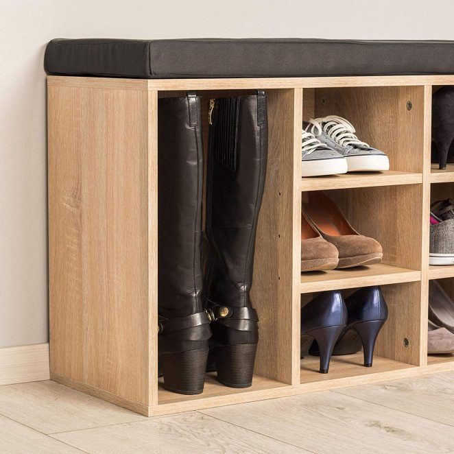 a wooden shoe rack with several pairs of shoes on the top and one pair of high heeled boots below