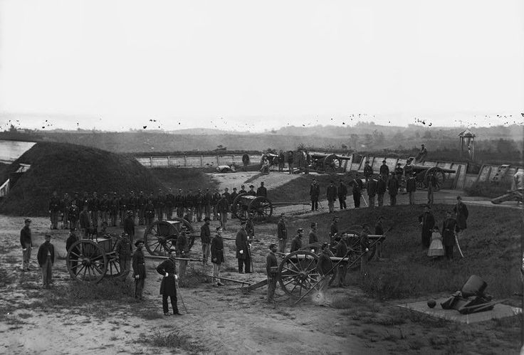 an old black and white photo of people standing around in front of horses drawn carriages