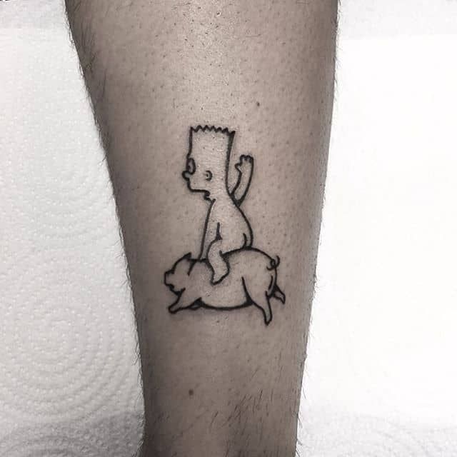 a person with a small tattoo on their leg that has a dog and cat sitting on it