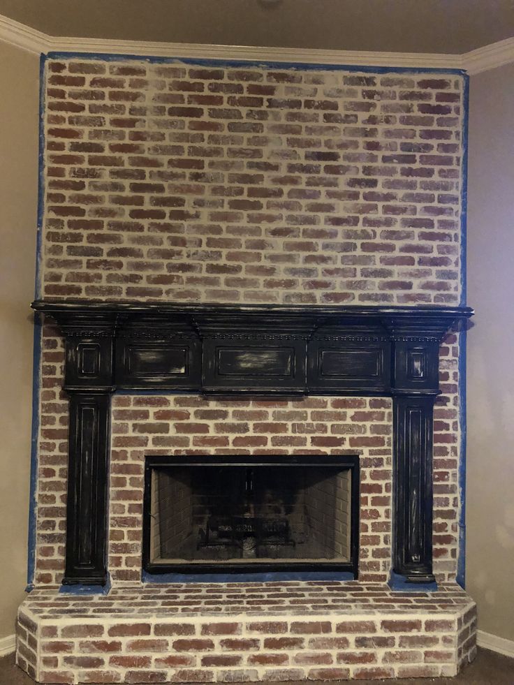 a brick fireplace with blue tape on the mantle