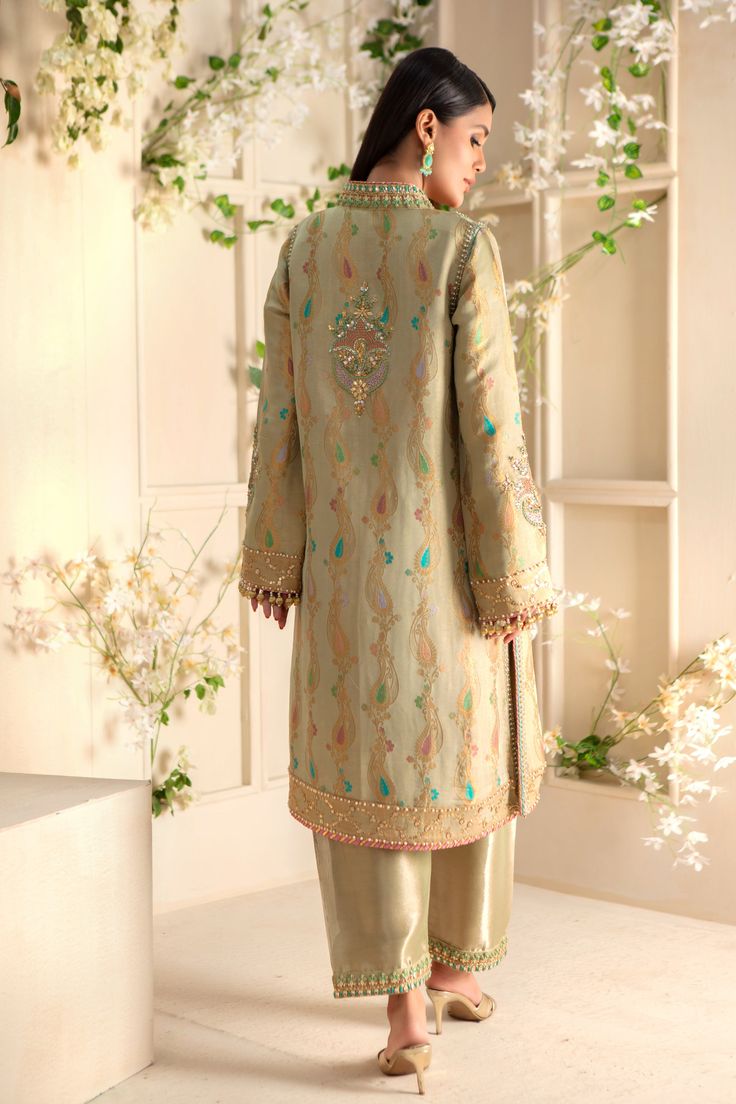 Gorgeous jacquard maysuri column shirt delicately embroidered with gota, tila, dabka, sequins, pearls & kundan work. Stunning maysuri dupatta with gota florals and sequins scattered motifs all over, & heavily, finished with opal hued atlas silk border and gota details adds a fun & festive element, handmade tassels on sleeves & dupatta for a perfect traditional feel.This stunning kurta is paired with tissue shalwar with hand embroidery to complete the look of this outfit, perfect for all celebrat Elegant Jamawar Lawn Suit For Festivals, Raw Silk Unstitched Suit With Dabka For Reception, Jamawar Unstitched Suit With Intricate Embroidery For Reception, Raw Silk Dupatta With Dabka For Reception, Unstitched Jamawar Suit With Intricate Embroidery For Reception, Jamawar Dupatta With Dabka For Reception, Reception Dupatta With Dabka On Jamawar, Festive Raw Silk Lawn Suit For Reception, Raw Silk Sets With Dabka For Reception