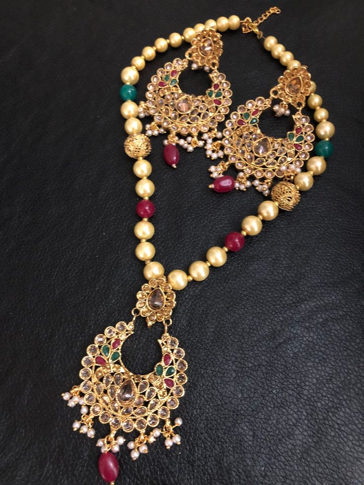 Look best with elegance and class! Set your own vibe! These uniquely designed polki champagne stones and multi beads mala and earrings set are made to glam up your look, going perfect with your outfit! Color : red/green In stock and ready to ship. Traditional Festive Jewelry With Natural Stones, Festival Kundan Necklace With Round Beads, Bollywood Style Necklace With Hand Set Round Beads, Festive Hand-set Kundan Necklace With Round Beads, Festive Chandbali Pearl Necklace Gift, Bollywood Style Festive Pearl Necklace Gift, Bollywood Style Mala With Stone Work For Puja, Pearl Necklace With Gemstone Beads For Festivals And Gifts, Elegant Multicolor Jewelry For Puja