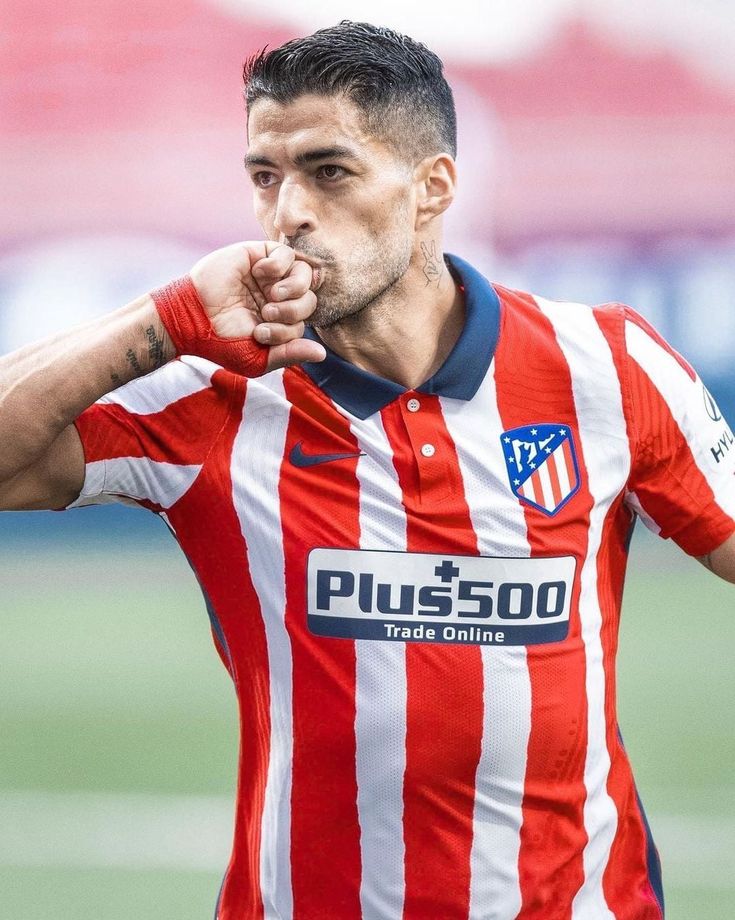 a close up of a soccer player holding his finger to his mouth