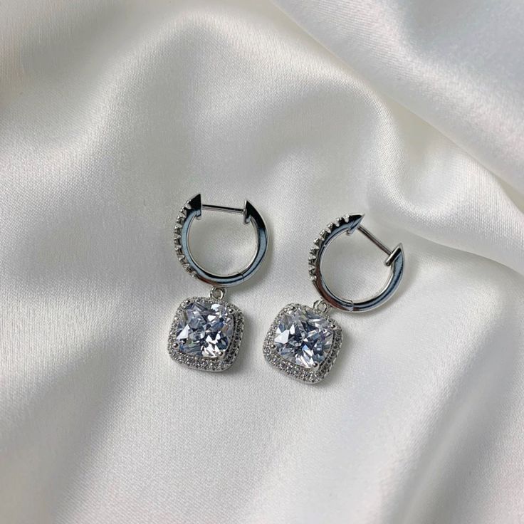 We are obsessed with these classy drop earrings! Perfect for a date, wedding, party or even a girls night out! So sparkly and classy you will become just as obsessed as us!  925 Sterling Silver Highest Grade CZ stones Water & Tarnish Resistant Hypoallergenic Diamond White Crystal Earrings For Party, Chic Silver Crystal Earrings, Dazzling Diamond White Crystal Earrings For Party, White Gold Crystal Bridal Earrings For Party, Party White Gold Diamond Crystal Earrings, Glamorous Formal Bridal Earrings With Sparkling Stones, Chic Silver Hoop Earrings For Formal Occasions, Glamorous Crystal Earrings As A Gift, White Gold Crystal Earrings For Party