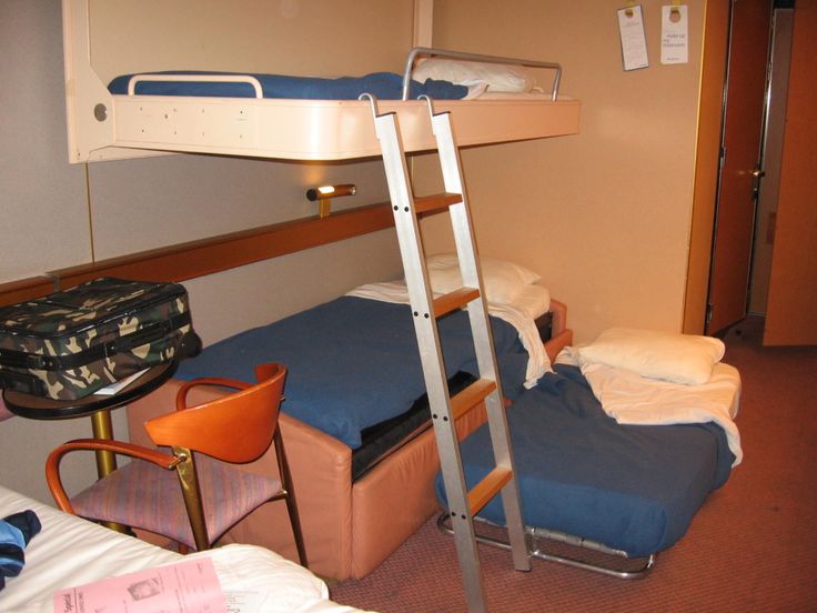 a bunk bed sitting next to a desk and chair