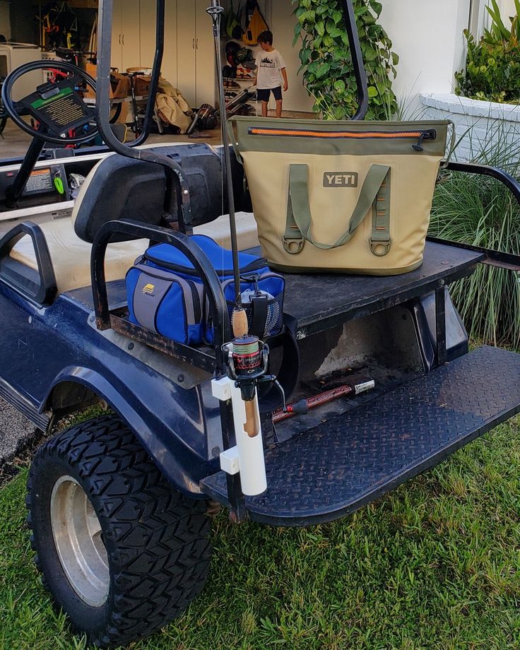 a golf cart with two bags on the back