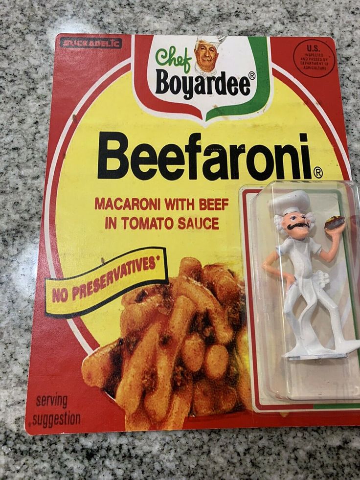 a package of beefaroni sitting on top of a counter next to a toy figure