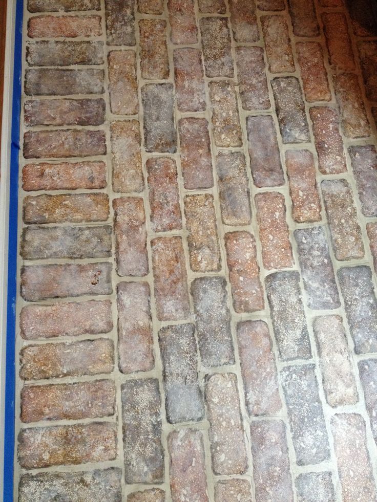 the floor is made out of bricks and has a blue border around it to protect them from dirt