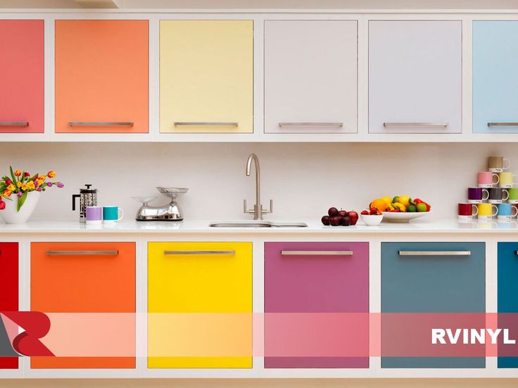 a kitchen with multi colored cabinets and counters