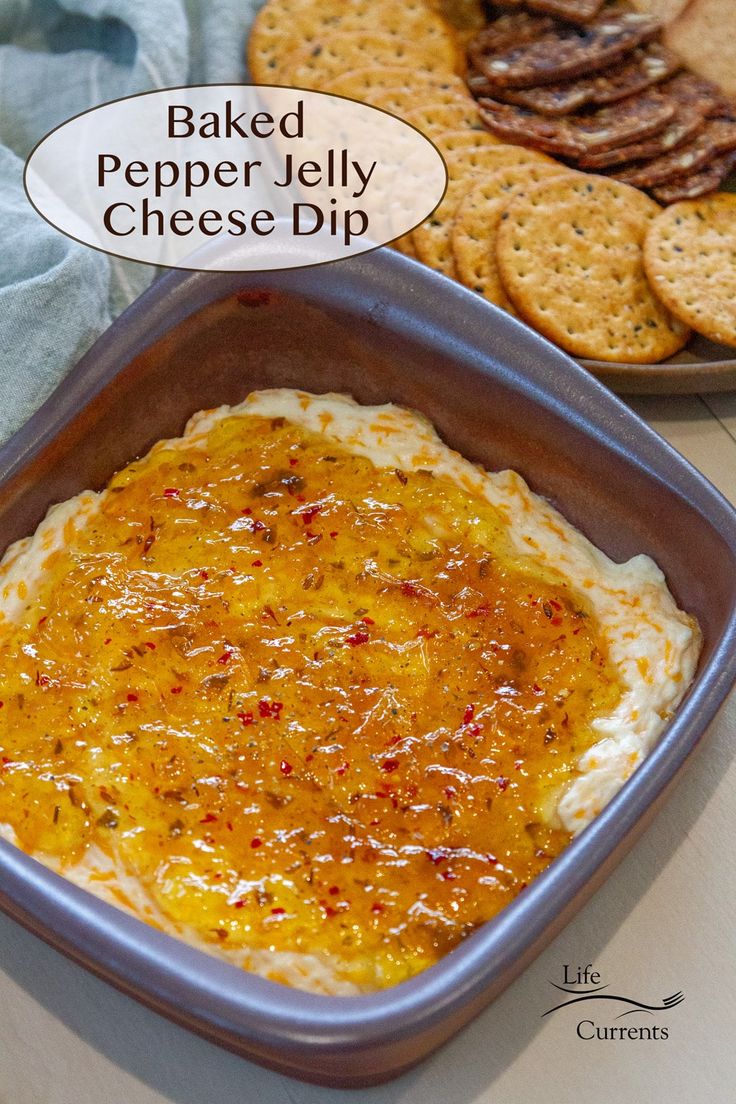 baked pepper jelly cheese dip with crackers in the background