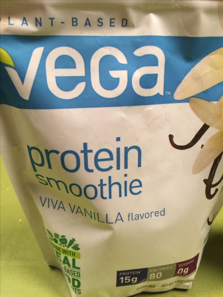 a bag of vegaa protein sitting on top of a green countertop next to a banana