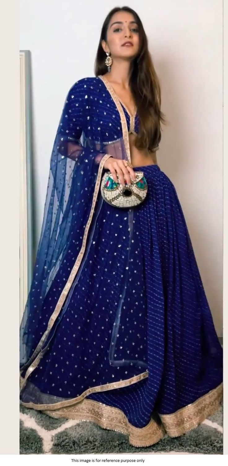 Bollywood Replica LehengaBollywood Model Blue color georgette designer lehenga With Digital Print With Heavy Sequence Work Border(Semi stitched : 5 mtr Flare With Cancan).Choli Fabric in Soft Georgette Fabric With Digital Print With Work Lace(Unstitched) Dupatta in Soft Net Fabric With Sequence Work. Semi stitched outfit that can be stitched to sizes till 42 inch size.Shipping time 5-7 days .Buy this Saree at Kollybollyethnics and make your occasion very special !!. With Express Free S Blue Sheer Dupatta Set For Navratri, Blue Georgette Anarkali Set With Cutdana, Blue Georgette Sharara For Reception, Blue Choli With Sheer Dupatta For Navratri, Blue Sharara For Navratri Reception, Blue Georgette Anarkali Set With Traditional Drape, Blue Cutdana Sharara For Party, Semi-stitched Blue Sets With Sheer Dupatta, Blue Georgette Salwar Kameez With Cutdana