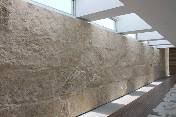 a large stone wall in an office building