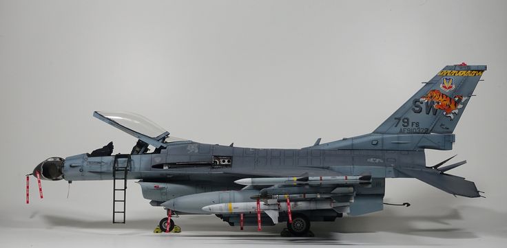 a model fighter jet sitting on top of a white table