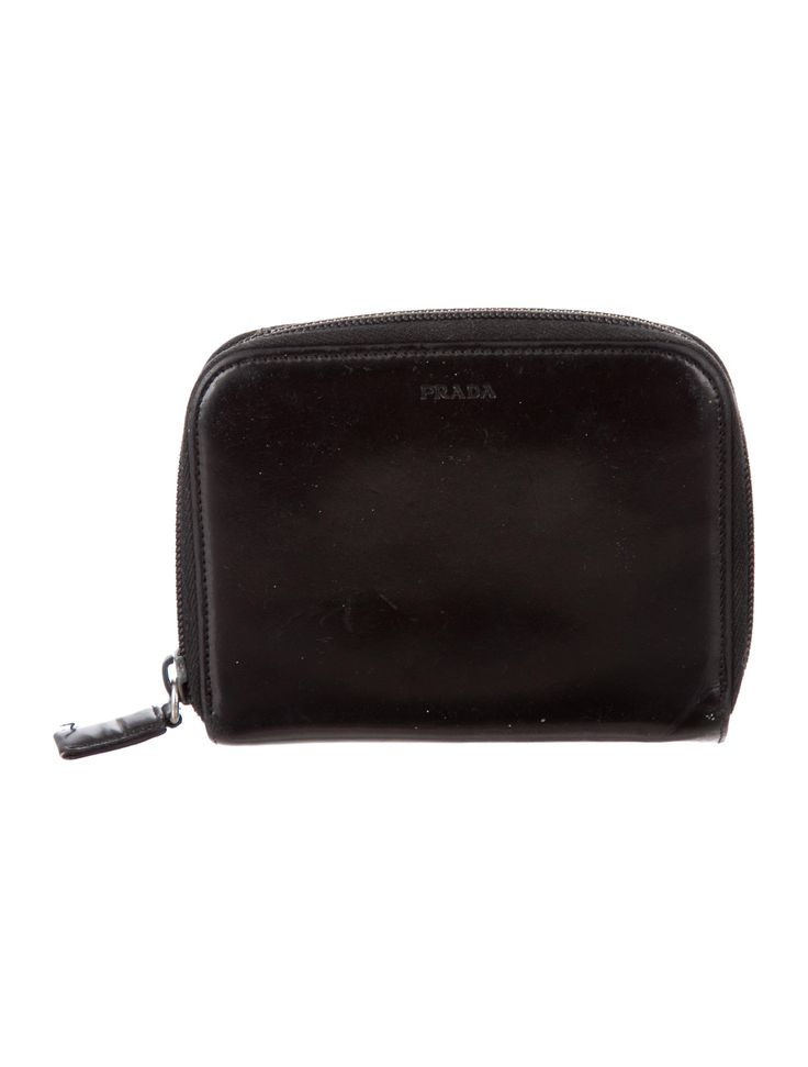 Black leather Prada compact wallet with tonal stitching, gusseted zip compartment at back, dual cash slots, ten card slots at interior and snap closure at side. Compact Wallet, Prada Leather, Snap Closure, Card Slots, Zip Around Wallet, Slots, Prada, Black Leather, Stitching