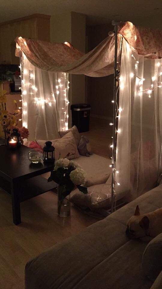 a living room filled with furniture covered in lights