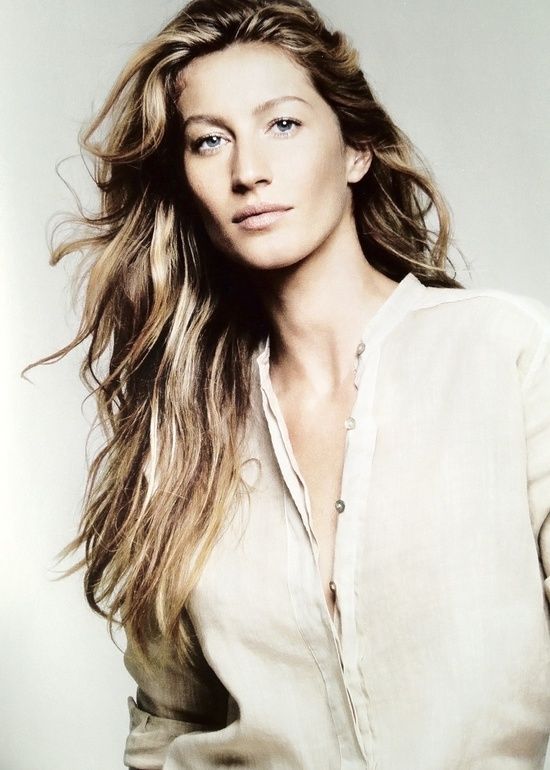 a woman with long hair posing for a photo