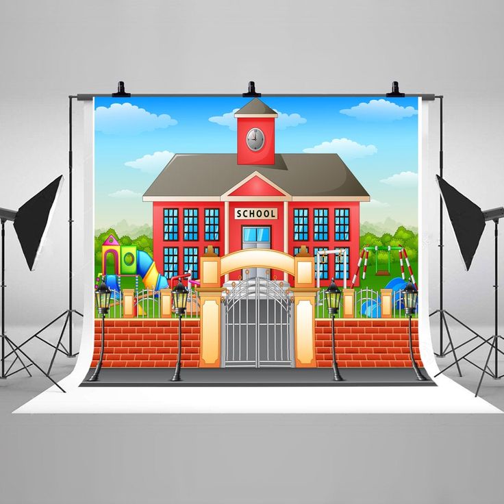 an image of a photo studio set up with the backdrop for a school building and gate