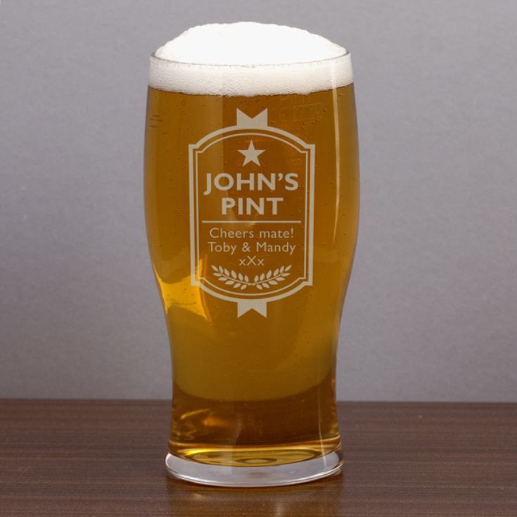 a pint glass sitting on top of a wooden table