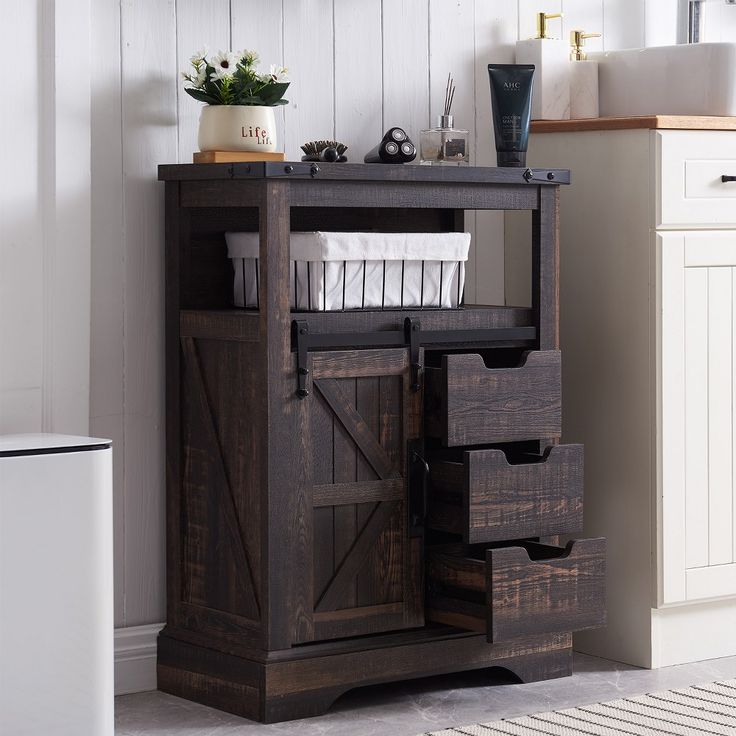 a wooden cabinet with drawers and baskets on top in a white room next to a sink