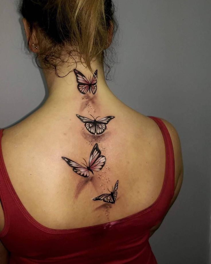 the back of a woman's neck with three butterflies on her upper and lower part