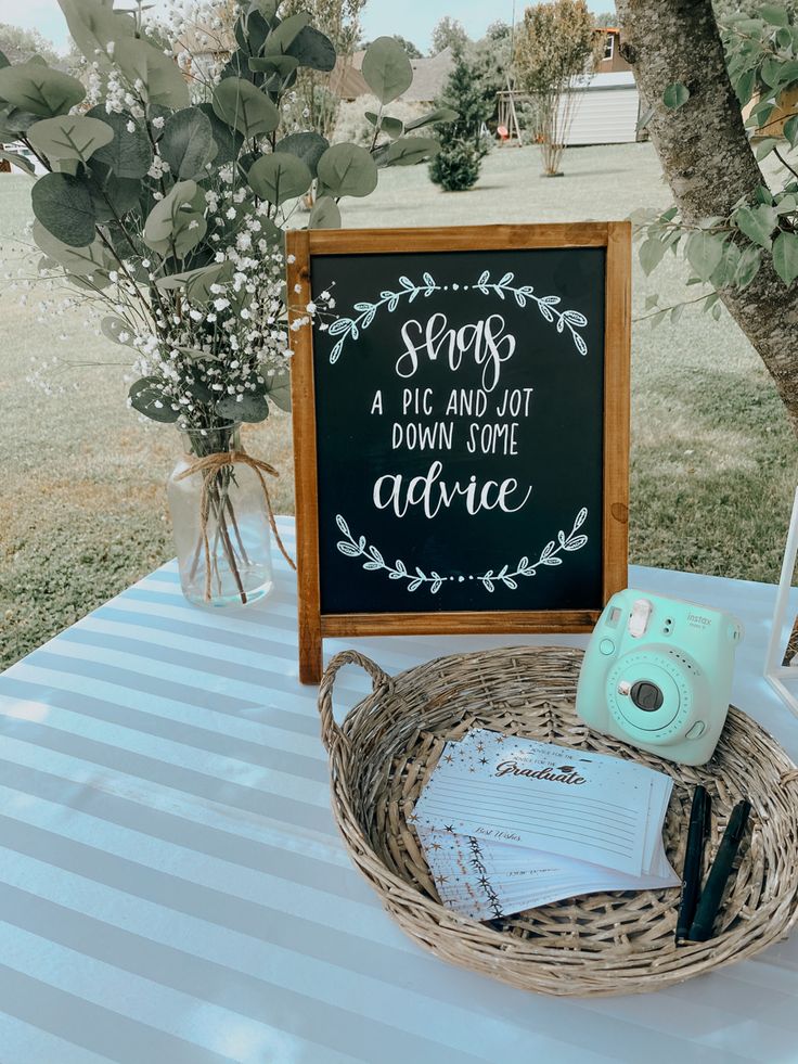 a table with a sign, camera and other items sitting on top of the table