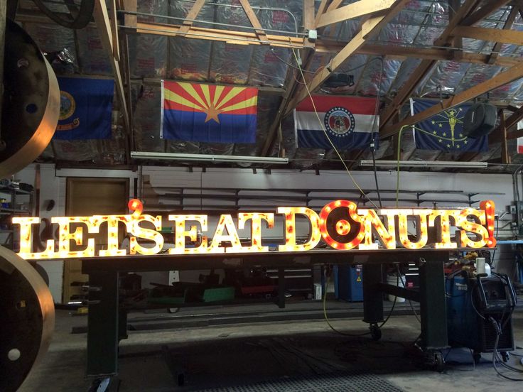 a sign that says let's eat donuts on it