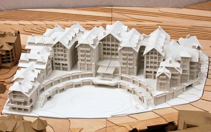 a model of a building with snow on the roof and in the middle of it