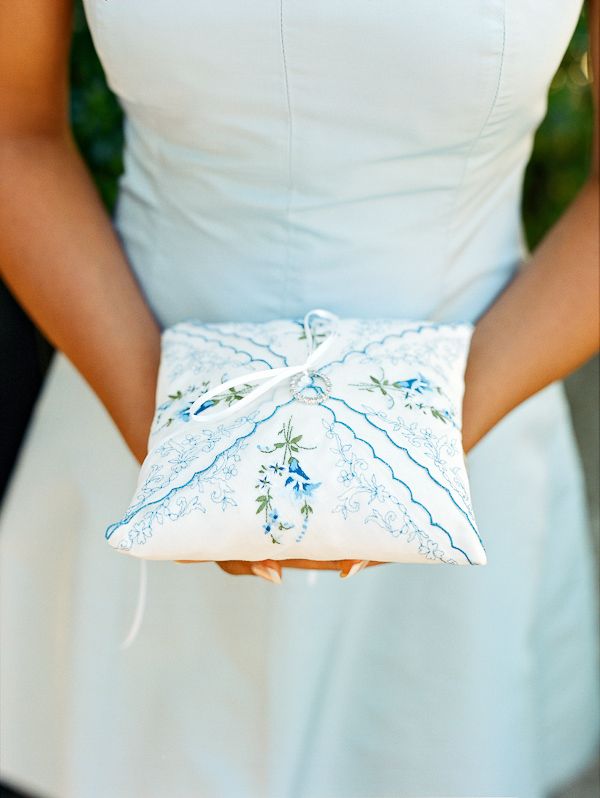 a woman in a white dress holding a pillow