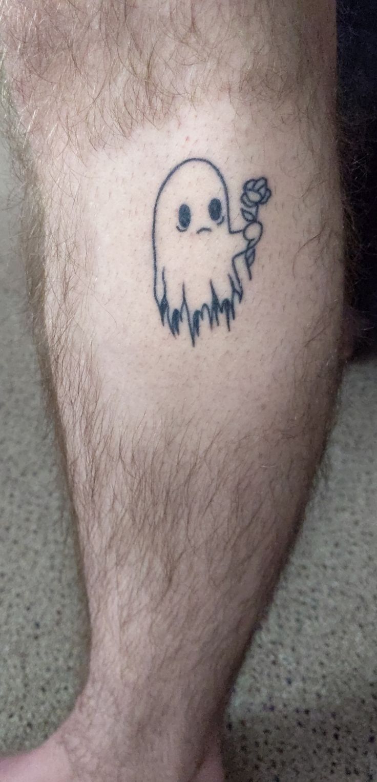 a man with a tattoo on his leg that has a ghost holding a rose in it