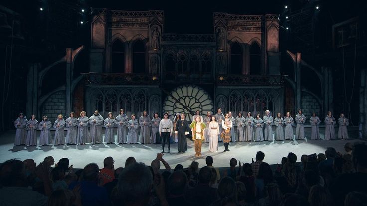 a group of people standing on top of a stage