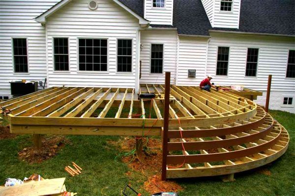 a wooden deck being built in front of a house