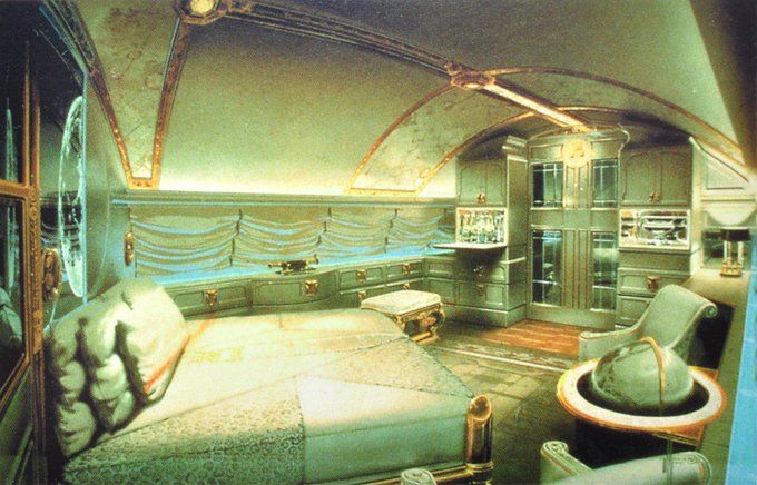 an artistic rendering of a bedroom in a futuristic space station with couches and tables