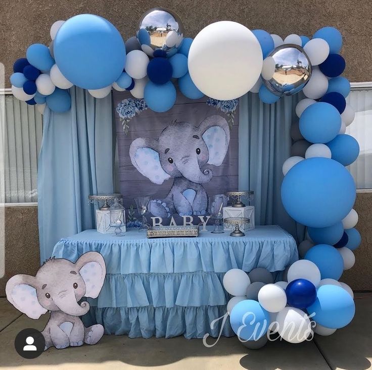 an elephant themed baby shower with blue and white balloons in the shape of a frame