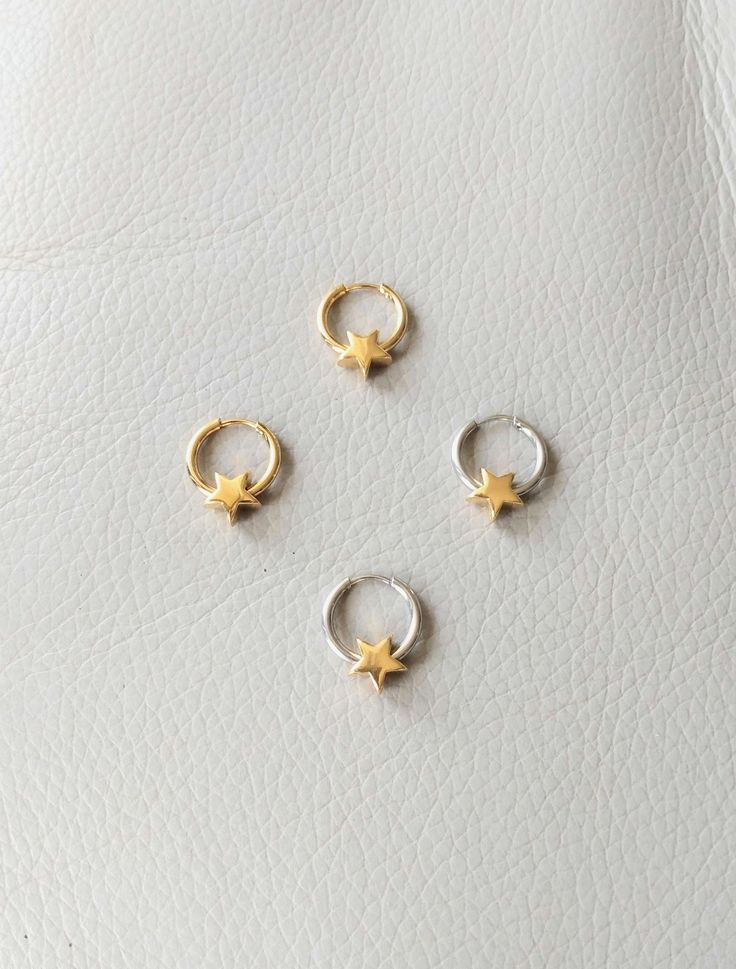 18K gold plated stainless steel, stainless steel. Star charm measures 9 mm x 9 mm. More earrings  https://www.etsy.com/shop/CornerByZ?ref=seller-platform-mcnav If you have any questions, please feel free to contact me. Celestial Star-shaped Huggie Earrings With Star Charm, Yellow Gold Star-shaped Tarnish Resistant Huggie Earrings, Dainty Gold Star Huggie Earrings, Star-shaped Tarnish Resistant Hoop Earrings For Everyday, Gold Star-shaped Huggie Earrings, Celestial Style Huggie Earrings With Star Charm, Gold Huggie Hoop Earrings With Star Charm, Gold Celestial Small Hoop Huggie Earrings, Gold Celestial Huggie Earrings For Everyday