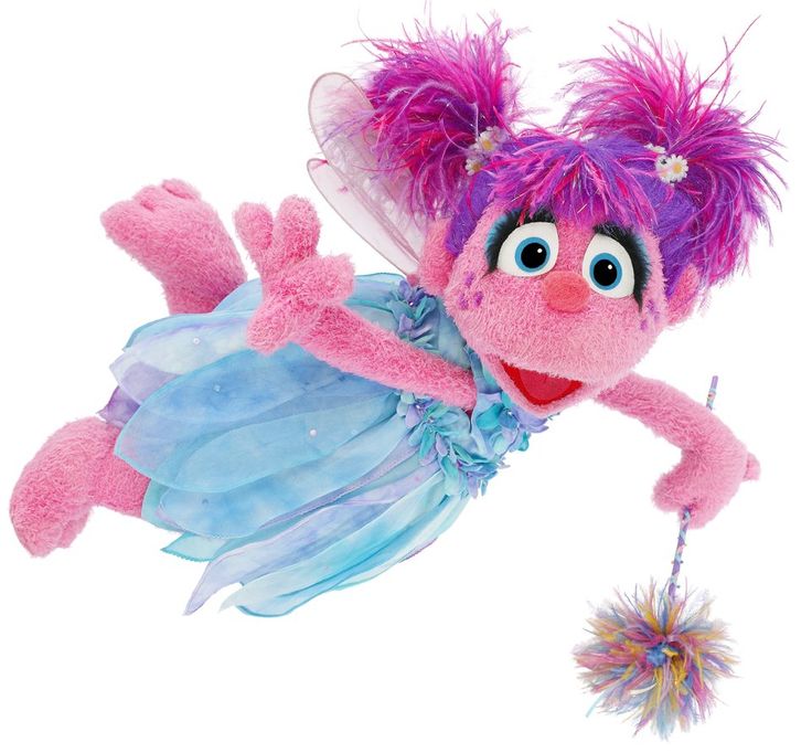 a pink stuffed animal with purple hair and blue dress on it's back, flying through the air