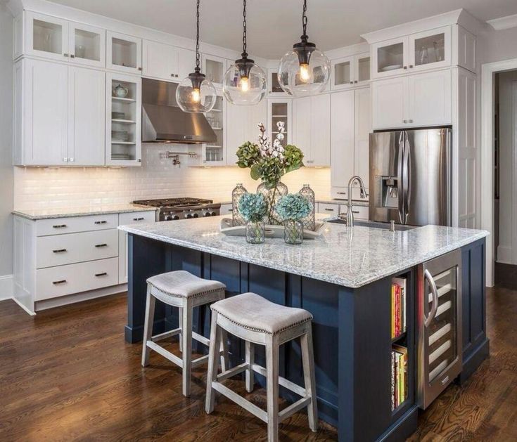 a kitchen island with two stools in front of it