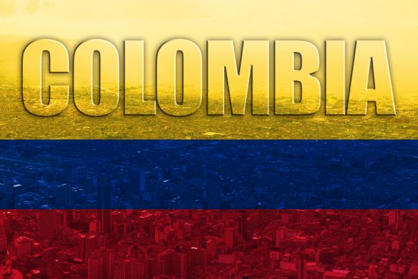 the word colombia painted in red, blue and yellow with an image of a city below it